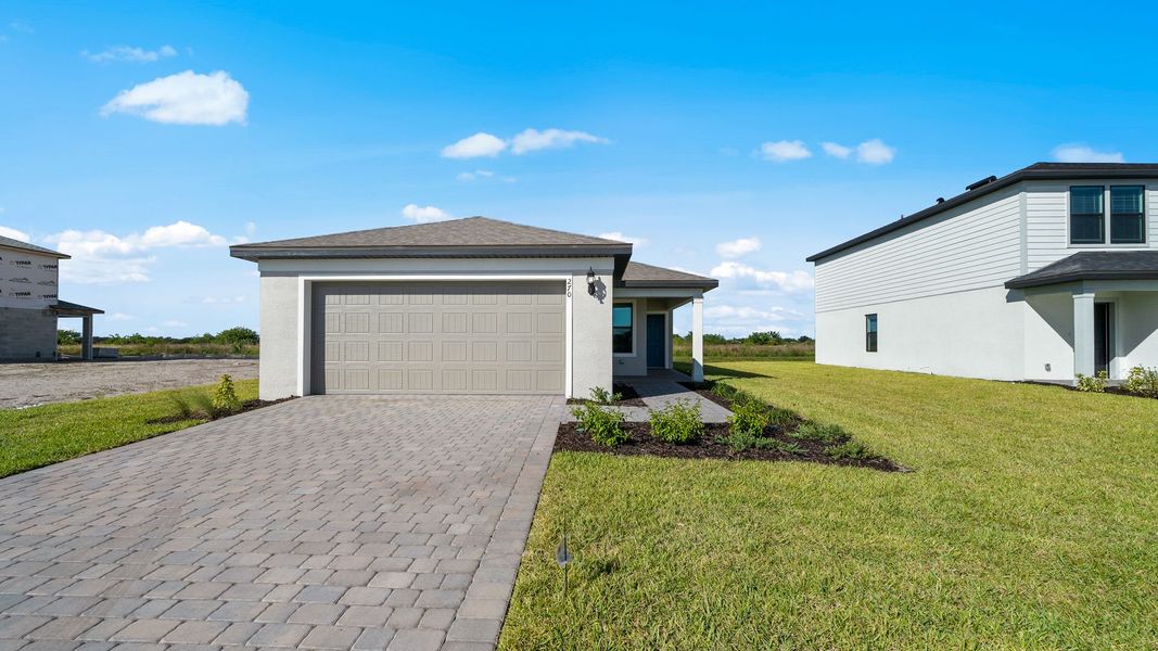 Front exterior of a new home in Whispering Lakes, Lehigh Acres, FL, highlighting curb appeal (Image 1). Front exterior of a new home in Whispering Lakes, Lehigh Acres, FL, highlighting curb appeal (Image 1).