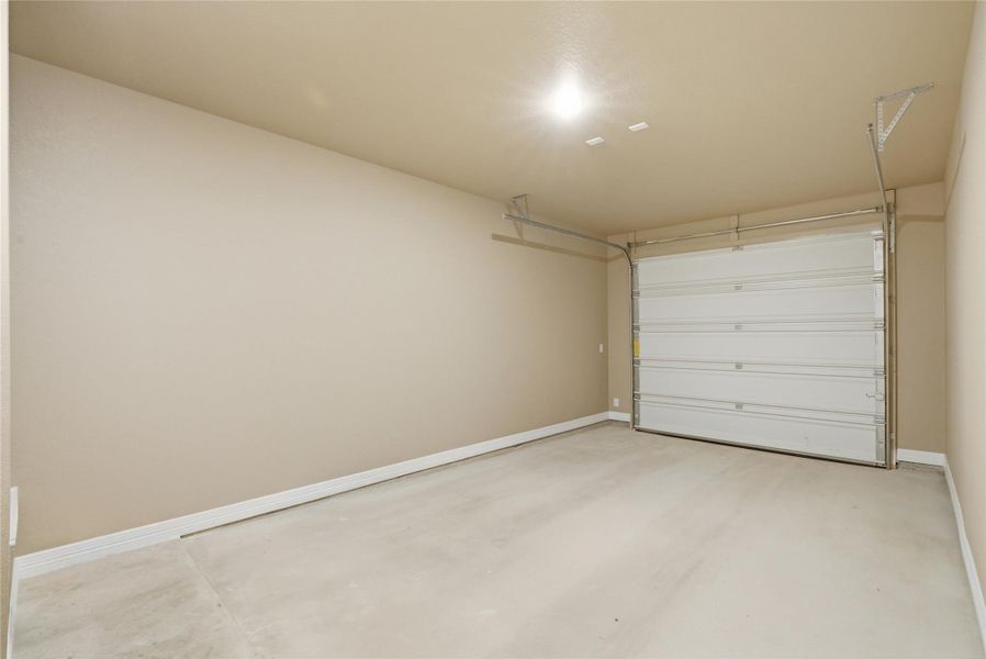 Garage featuring baseboards