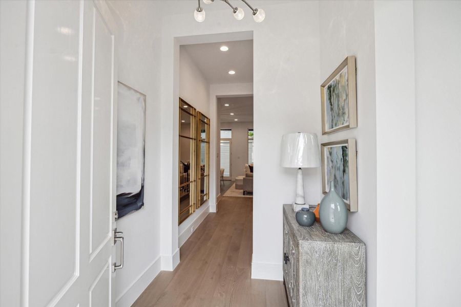Step into this bright and welcoming formal entry. The first floor living space features 11-foot ceilings, Legno Bastone engineered White Oak wood floors, and designer light fixtures. Step into this bright and welcoming formal entry. The first floor living space features 11-foot ceilings, Legno Bastone engineered White Oak wood floors, and designer light fixtures.