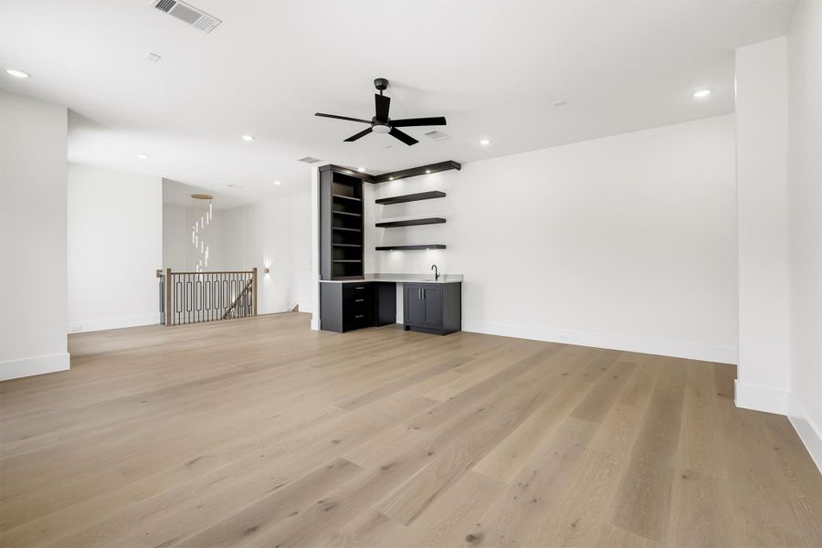 The dedicated game room upstairs features a wet bar. A perfect place to enjoy time with family and friends.
