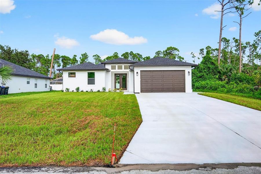 Front exterior of a new home in , North Port, FL, highlighting curb appeal (Image 2). Front exterior of a new home in , North Port, FL, highlighting curb appeal (Image 2).
