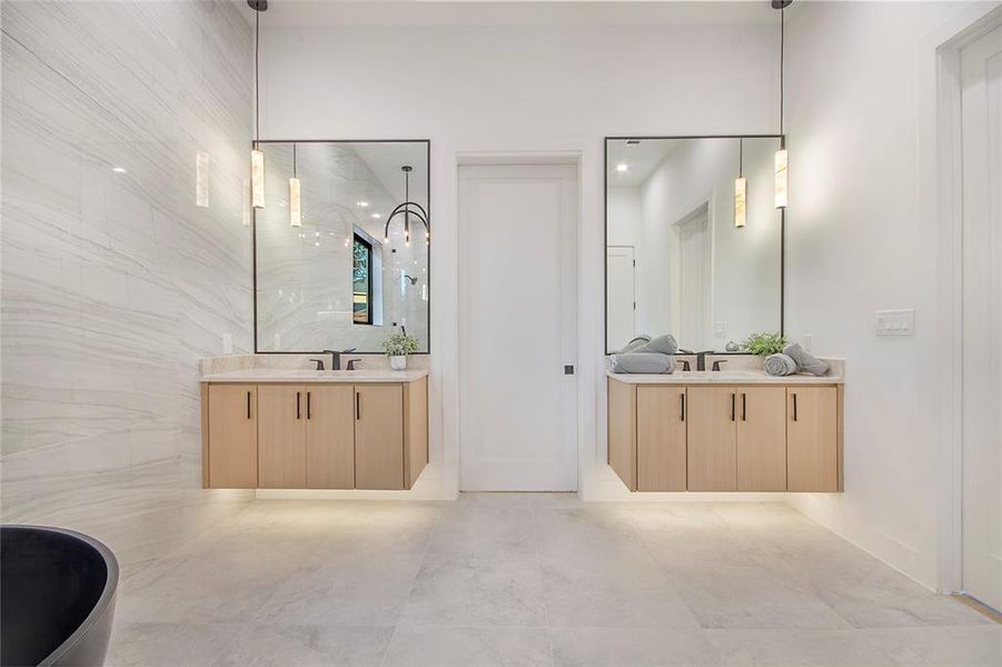Bathroom with two vanities and tile walls