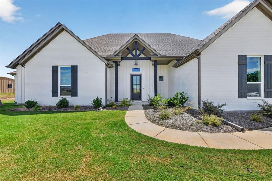 Contemporary farmhouse exterior featuring white brick and dark trim Contemporary farmhouse exterior featuring white brick and dark trim