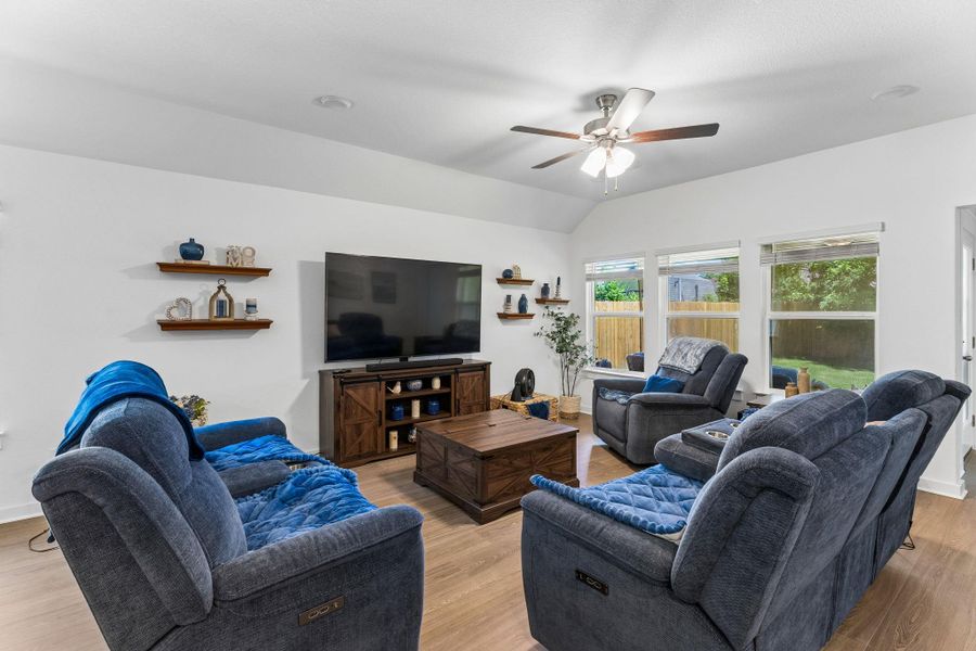 Spacious living room overlooking backyard.