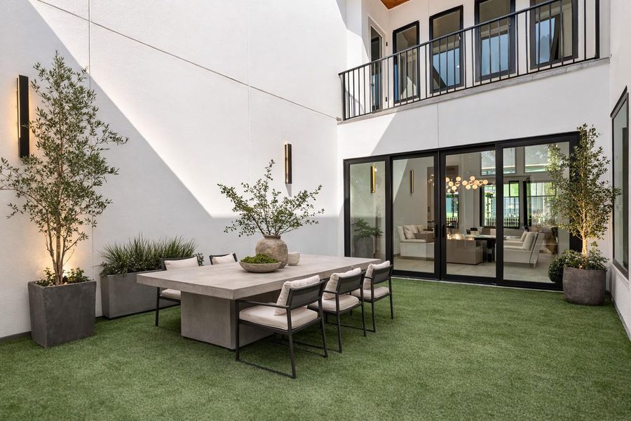 A fully turfed private courtyard, just off the dining room and foyer, offers a rare retreat in the city- destined to be your favorite gathering space and a true showpiece for entertaining. *Virtual representation as an outdoor  dining experience*