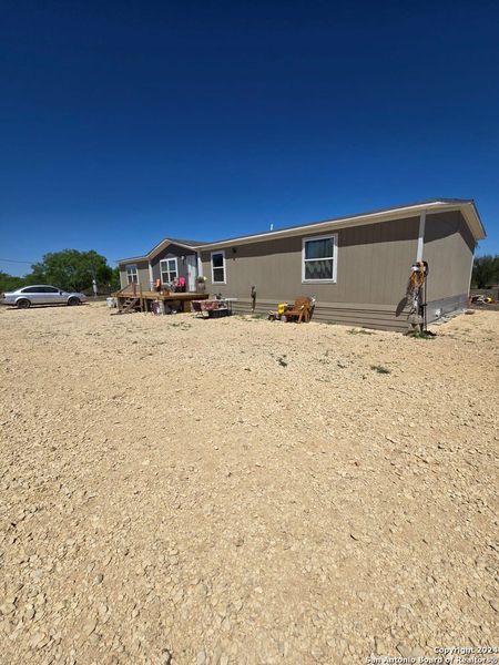Front exterior of a new home in , La Pryor, TX, highlighting curb appeal (Image 7).