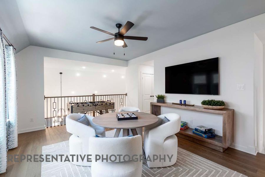 Dining room with a ceiling fan, wood finished floors, and lofted ceiling Dining room with a ceiling fan, wood finished floors, and lofted ceiling