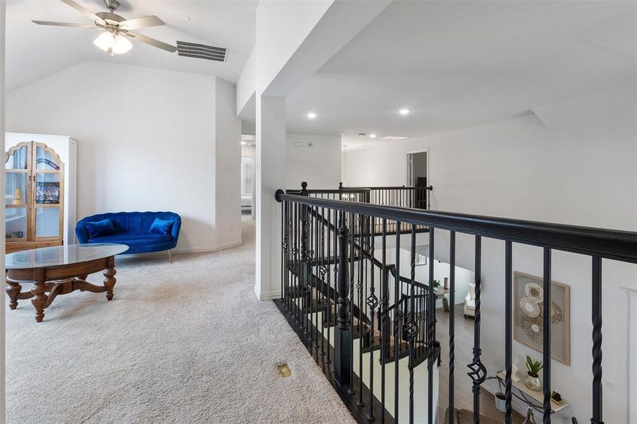 Hall with an upstairs landing, carpet flooring, recessed lighting, and lofted ceiling
