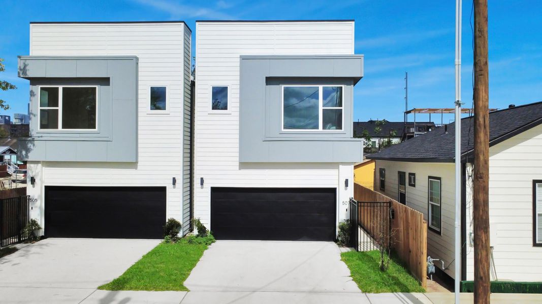 This modern home boasts sleek architecture and a private driveway, offering both style and seclusion.