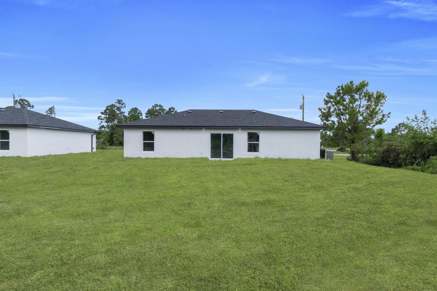 Front exterior of a new home in , Lehigh Acres, FL, highlighting curb appeal (Image 14).