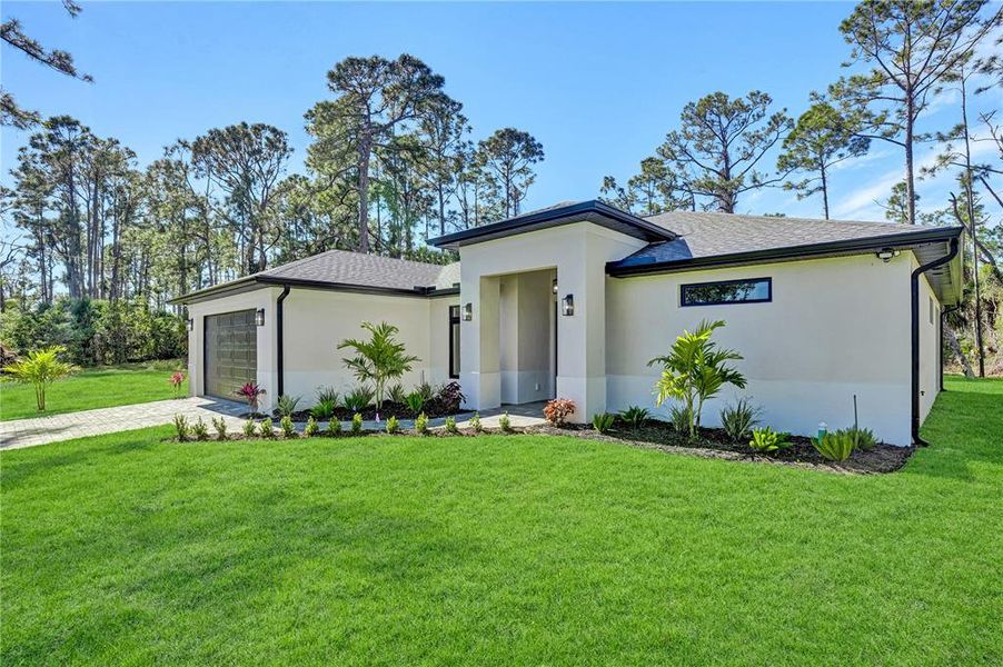 Front exterior of a new home in , North Port, FL, highlighting curb appeal (Image 25). Front exterior of a new home in , North Port, FL, highlighting curb appeal (Image 25).