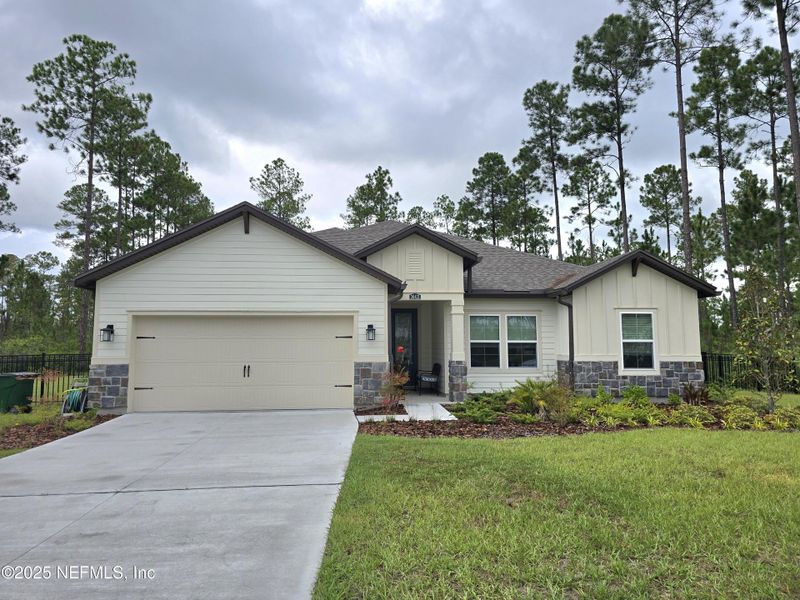 Front exterior of a new home in , Hilliard, FL, highlighting curb appeal (Image 1).