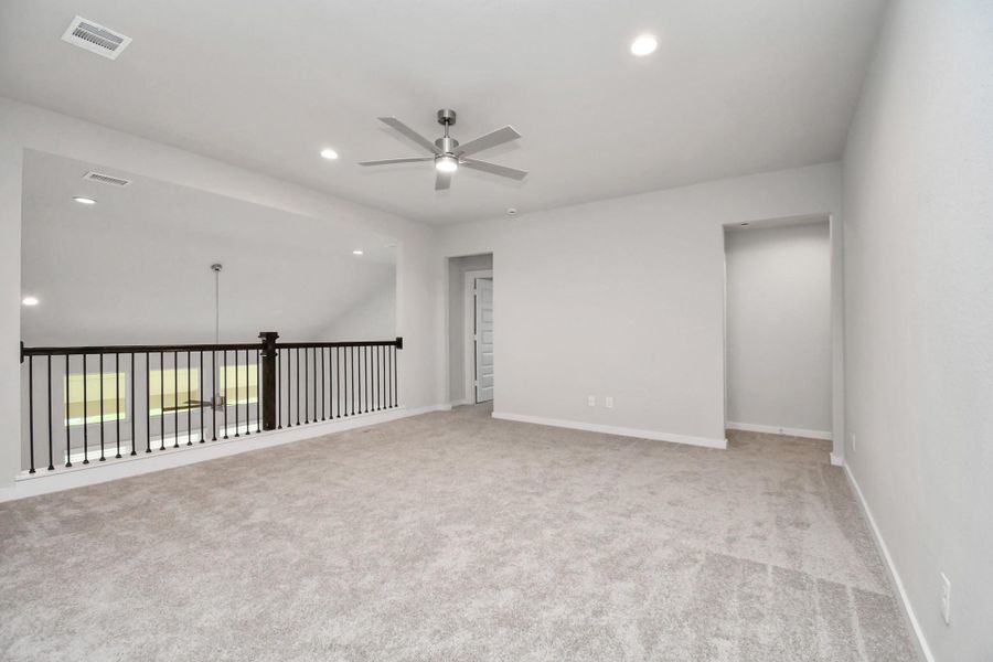 Elevate your leisure in this fantastic game room! Perfect for casual gatherings and adult gaming, it features plush carpet, high ceilings, custom paint, and numerous windows that welcome in ample natural light. Sample photo of completed home with similar floor plan. Actual colors and selections may vary. Elevate your leisure in this fantastic game room! Perfect for casual gatherings and adult gaming, it features plush carpet, high ceilings, custom paint, and numerous windows that welcome in ample natural light. Sample photo of completed home with similar floor plan. Actual colors and selections may vary.