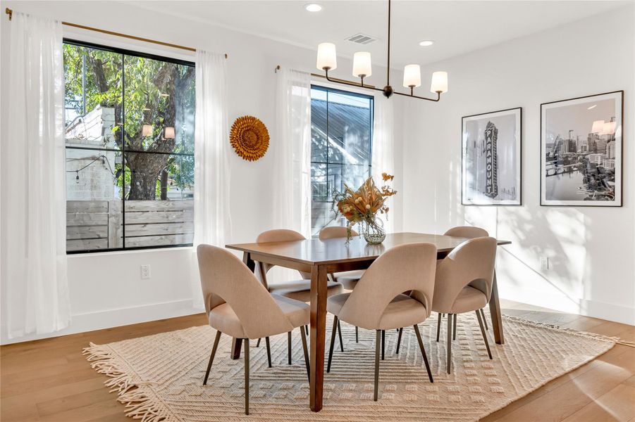 Dining space featuring healthy amount of natural light, light wood finished floors, and recessed lighting Dining space featuring healthy amount of natural light, light wood finished floors, and recessed lighting