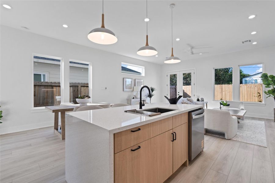 Expansive windows wrap around the home, flooding every room with natural light and highlighting the warm, Scandinavian-inspired design. This abundance of sunlight enhances the open, airy layout, creating a welcoming and uplifting atmosphere. Imagine relaxing in a space that feels bright, cozy, and perfectly connected to the outdoors.