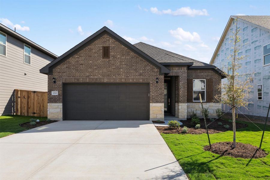 Front exterior of a new home in Patterson Ranch, Georgetown, TX, highlighting curb appeal (Image 2). Front exterior of a new home in Patterson Ranch, Georgetown, TX, highlighting curb appeal (Image 2).
