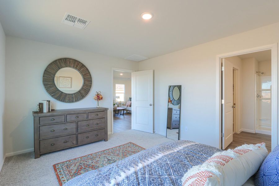 A bedroom with a bed and dresser. A bedroom with a bed and dresser.