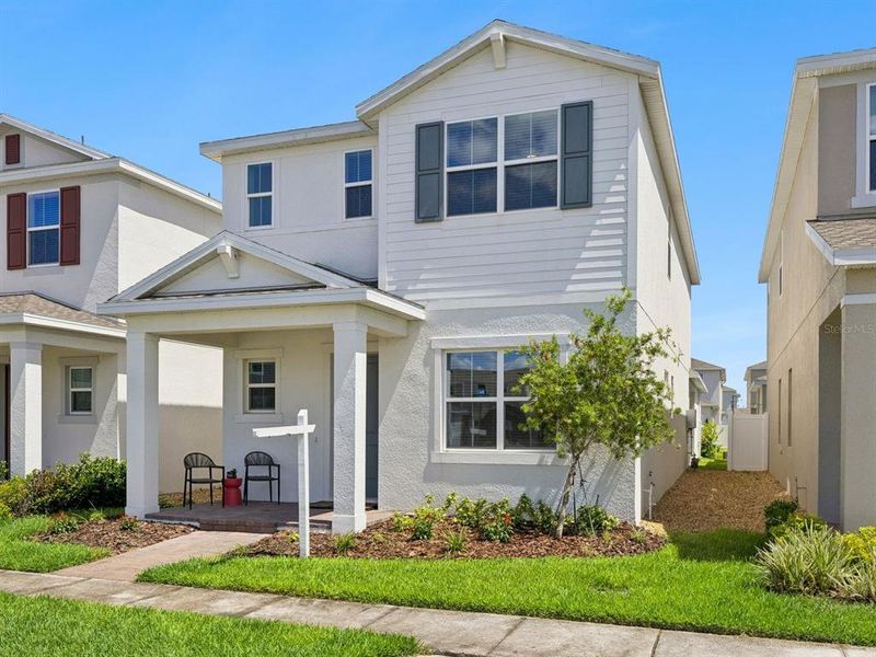 Front exterior of a new home in Osprey Ranch, Winter Garden, FL, highlighting curb appeal (Image 23).