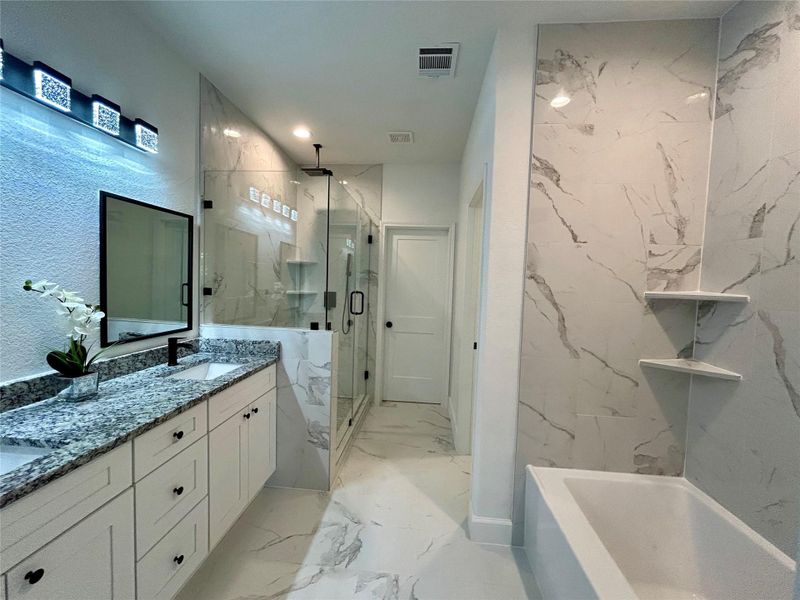 Shower and tub in the primary bathroom.