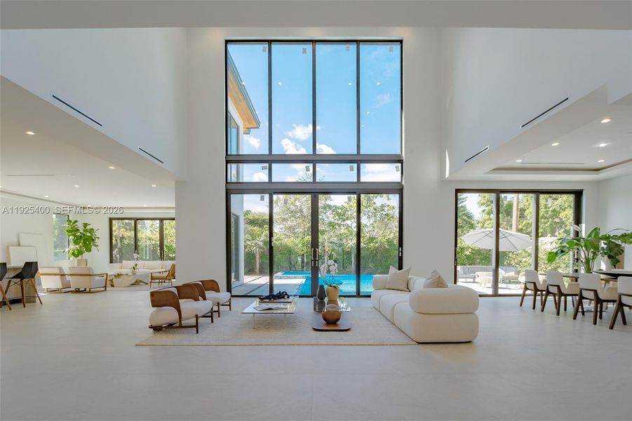 Modern living area with large glass slinding doors that offers a Panoramic view and access to an exterior area. Modern living area with large glass slinding doors that offers a Panoramic view and access to an exterior area.