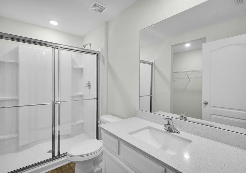 The master bathroom has a walk-in shower and spacious vanity