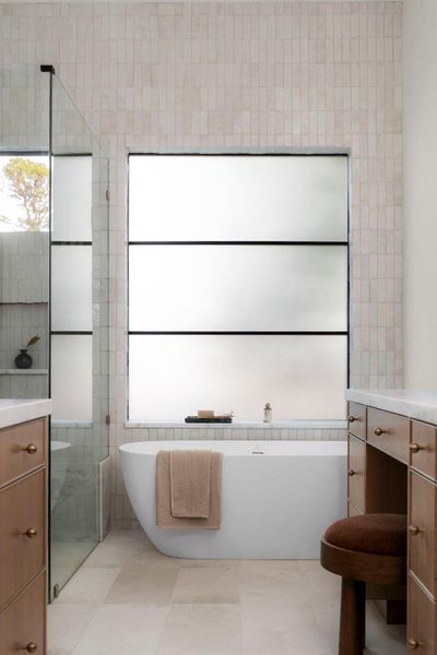 Full bath with vanity, tile walls, a freestanding tub, and walk in shower