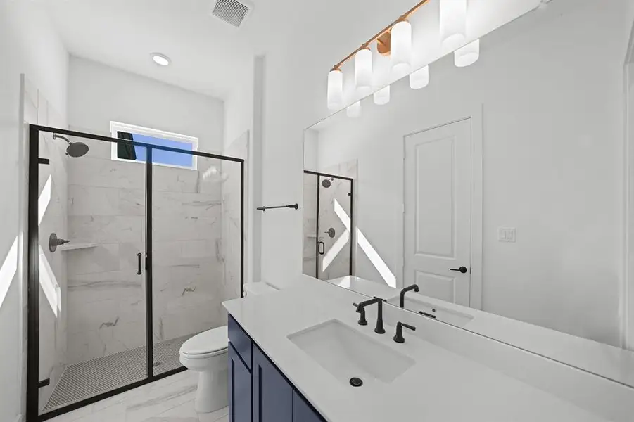 Full bathroom featuring a marble finish shower, vanity, light marble finish flooring, and recessed lighting Full bathroom featuring a marble finish shower, vanity, light marble finish flooring, and recessed lighting