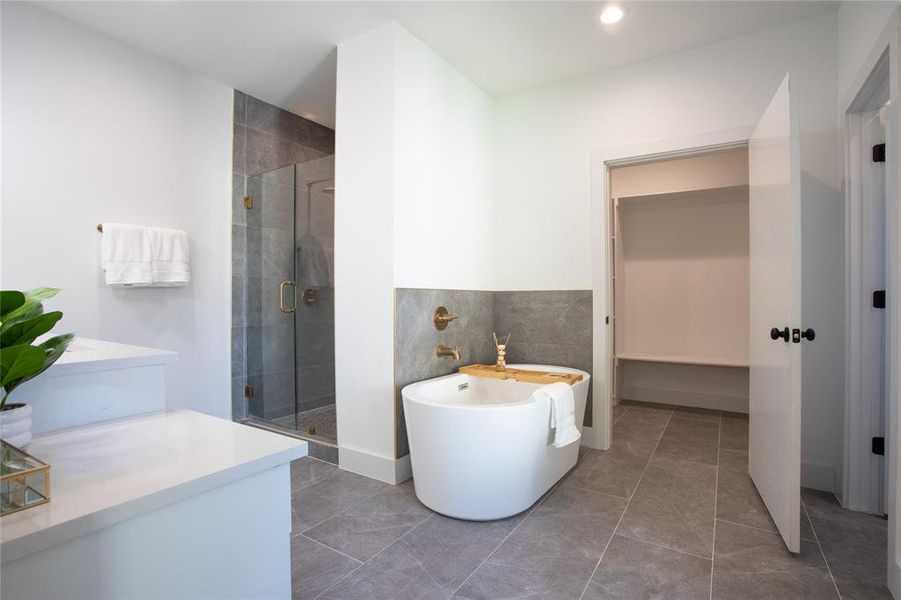 Bathroom with tile patterned floors and plus walk in shower