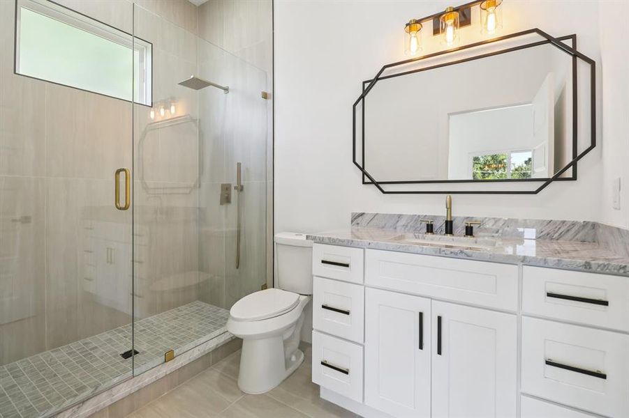 Full bath featuring a shower stall and vanity