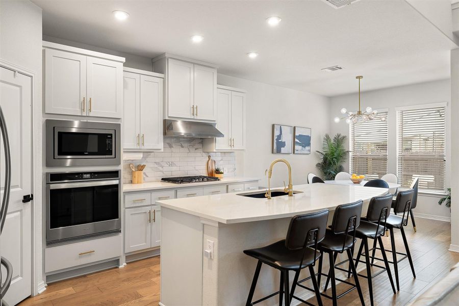 The new kitchen sink ties the cabinetry and countertops together with a clean, fresh finish