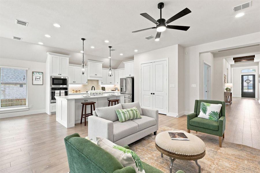 An open concept living area seamlessly blends with the kitchen, creating an ideal space for entertaining.
