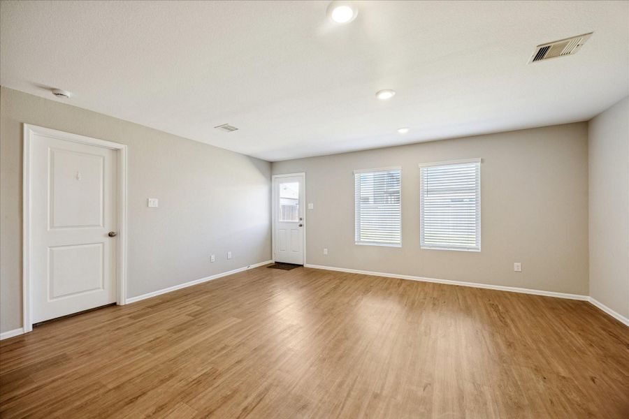 Bright and spacious Family Room with light flooring, neutral walls, and recessed lighting, creating an inviting and versatile living area.
