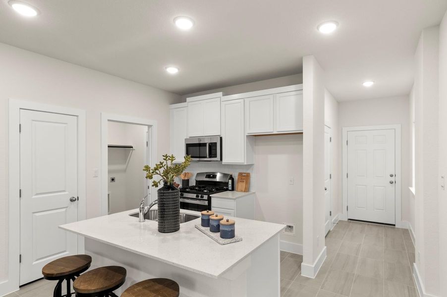 Modern kitchen with white shaker cabinets and a spacious island, perfect for casual dining and entertaining.