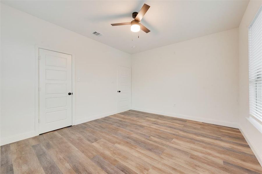 Empty room featuring ceiling fan and light wood-type flooring