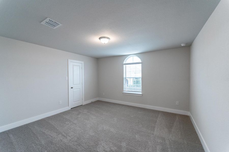 Empty room with carpet floors and baseboards