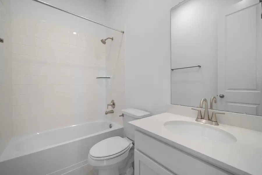 The secondary bath features tile flooring, white cabinetry and light countertops and a shower/tub combo. Perfect for accommodating any visiting family and friends. The secondary bath features tile flooring, white cabinetry and light countertops and a shower/tub combo. Perfect for accommodating any visiting family and friends.