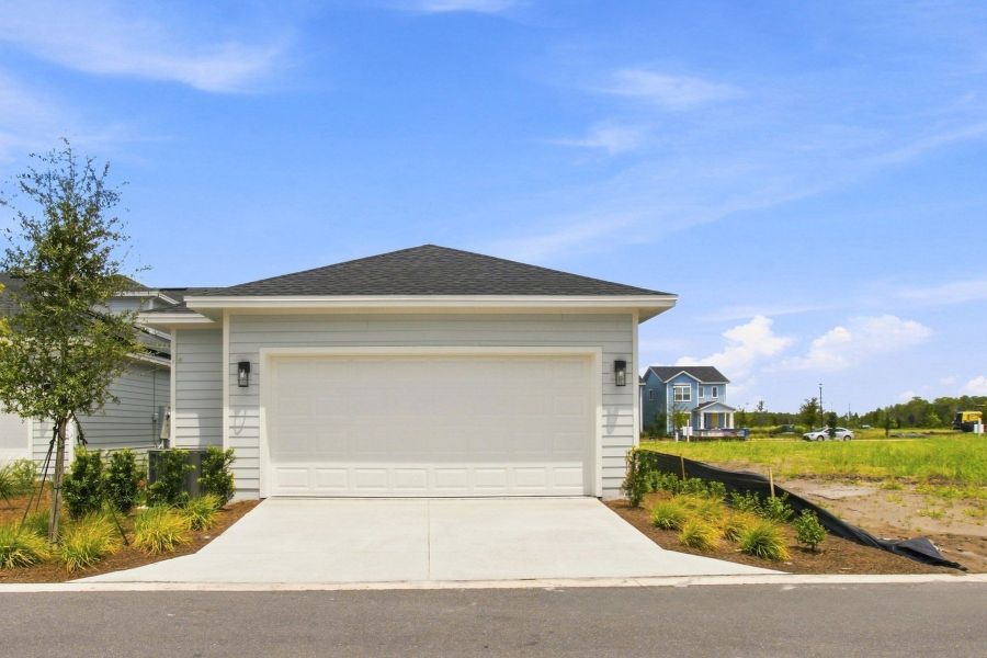 Front exterior of a new home in Weslyn Park in Sunbridge 34', St. Cloud, FL, highlighting curb appeal (Image 1). Front exterior of a new home in Weslyn Park in Sunbridge 34', St. Cloud, FL, highlighting curb appeal (Image 1).