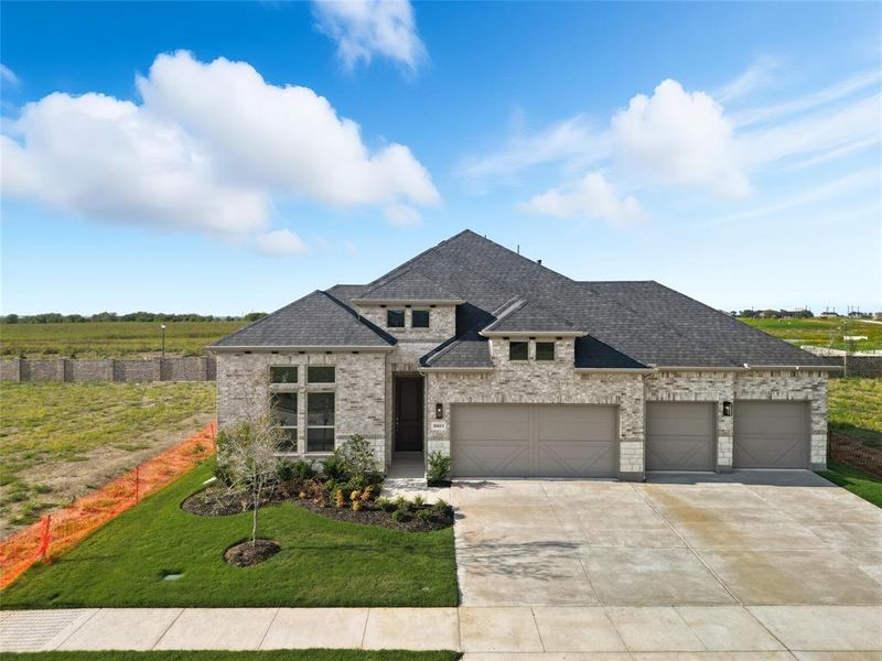 French provincial home featuring concrete driveway, brick siding, a shingled roof, and a garage French provincial home featuring concrete driveway, brick siding, a shingled roof, and a garage