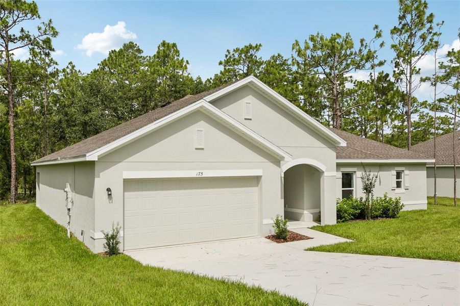 Front exterior of a new home in Sugarmill Woods, Homosassa, FL, highlighting curb appeal (Image 6).