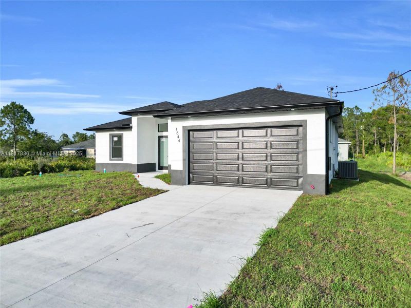 Front exterior of a new home in , Lehigh Acres, FL, highlighting curb appeal (Image 20). Front exterior of a new home in , Lehigh Acres, FL, highlighting curb appeal (Image 20).