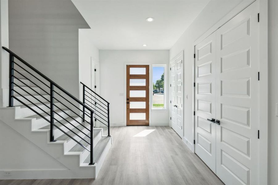 Foyer entrance with light hardwood / wood-style flooring