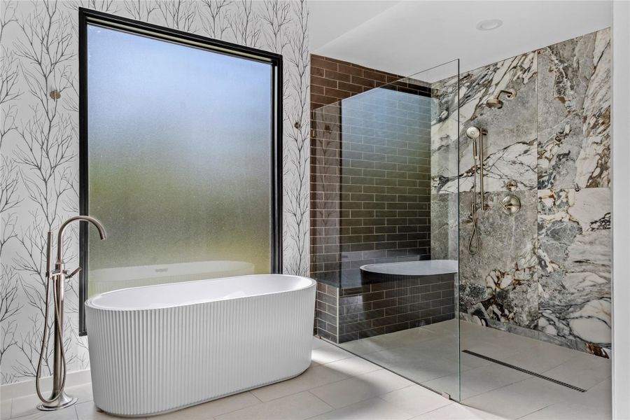 Full bath with tile patterned floors, walk in shower, and a freestanding bath