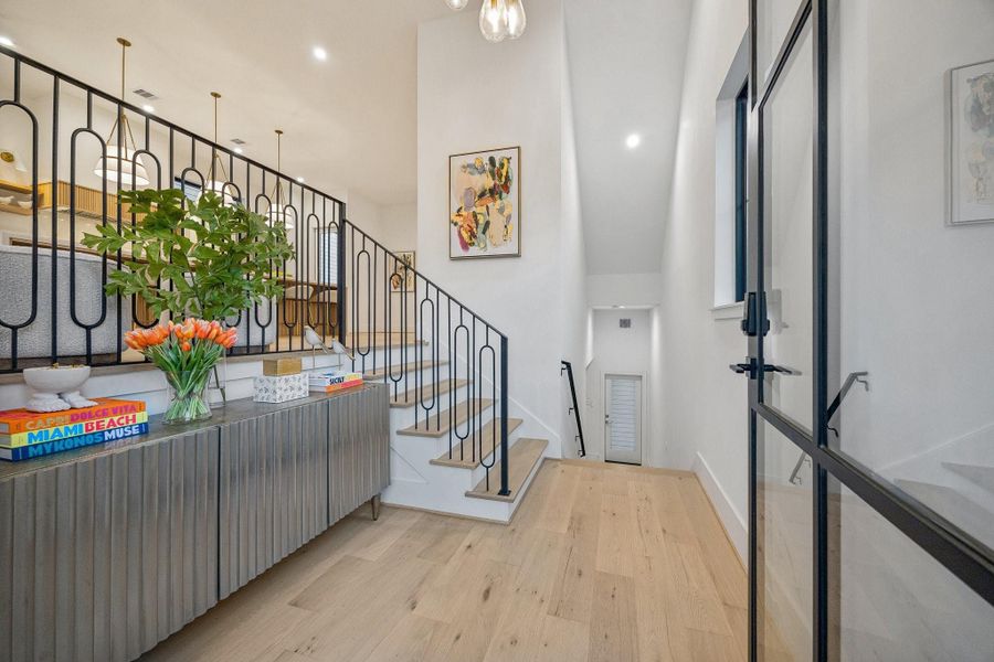 The entrance of the home makes a striking first impression with its clean, modern sophistication and airy scale.