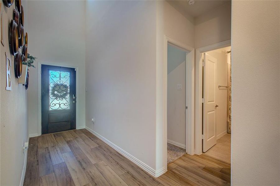 Entrance foyer with light hardwood / wood-style flooring