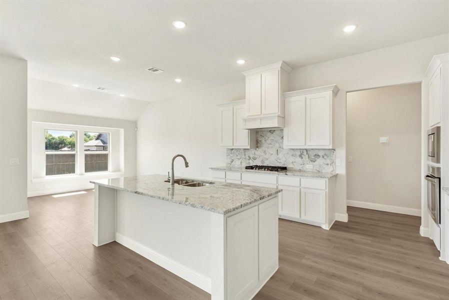 Kitchen island with a granite countertop and an undermount sink Kitchen island with a granite countertop and an undermount sink