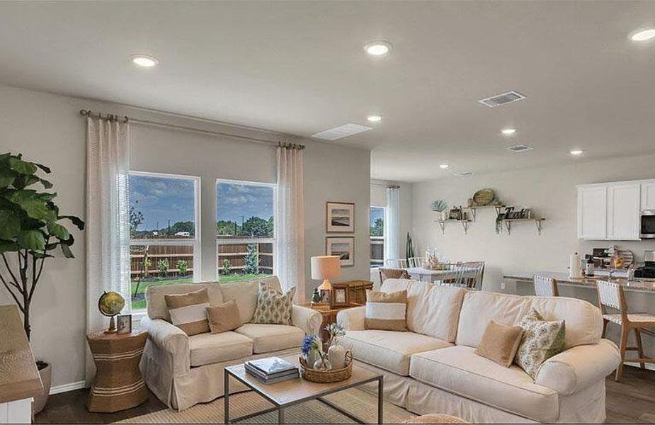 Living room featuring recessed lighting, dark wood finished floors, and baseboards Living room featuring recessed lighting, dark wood finished floors, and baseboards