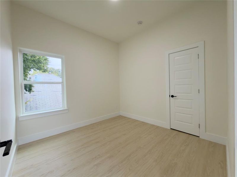 Unfurnished room featuring light wood-type flooring and baseboards