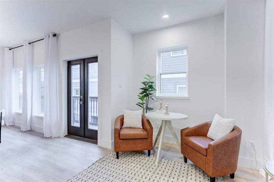 The flexible space on the side of the living room has its own special light and the doorway leads to the second floor balcony.