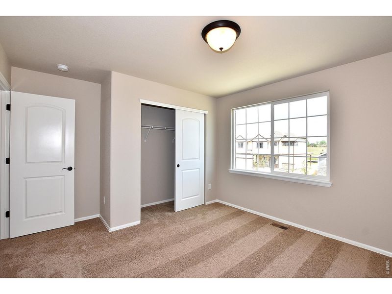 Spacious, unfurnished interior of a new home in Union Colony West, Greeley (Image 33).