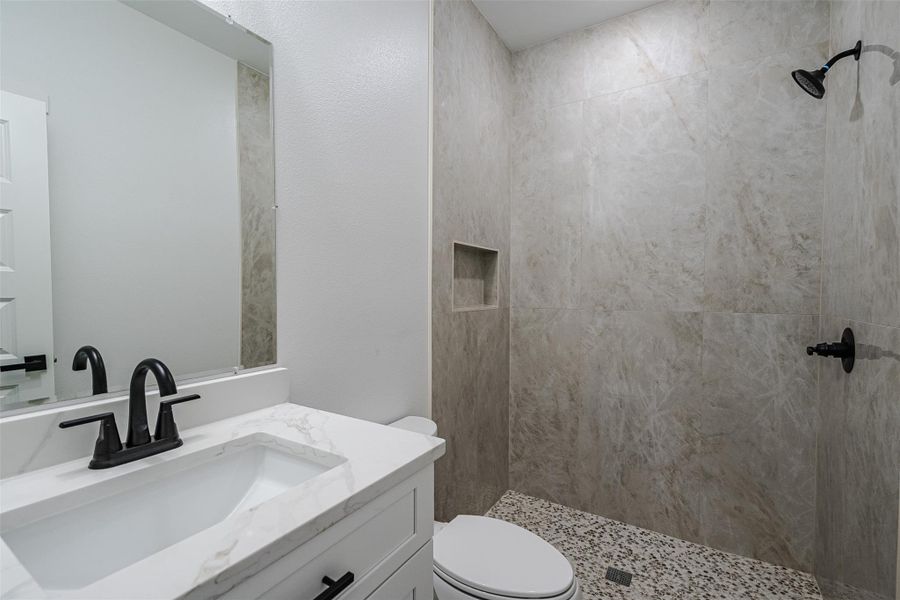 A well-appointed bath features a sleek vanity, modern fixtures, and a spacious walk-in shower. A well-appointed bath features a sleek vanity, modern fixtures, and a spacious walk-in shower.